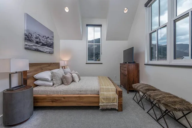 Bedroom with a king bed and dual mountain-view windows