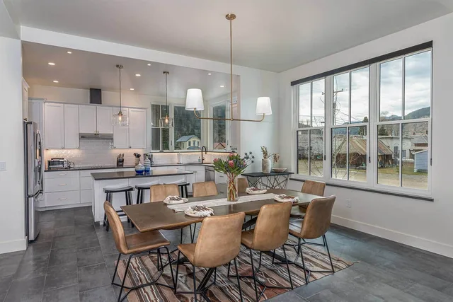 Dining area and gourmet chef's kitchen with stainless steel appliances