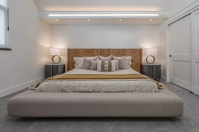 Master suite with a king bed, live-edge headboard, and warm alpine styling